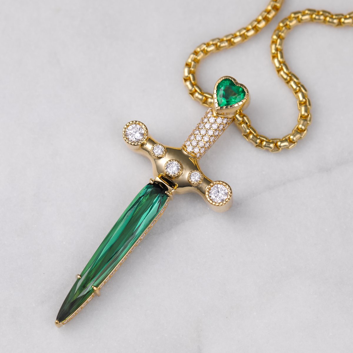 Custom dagger pendant with a green tourmaline blade, heart emerald and diamonds in yellow gold